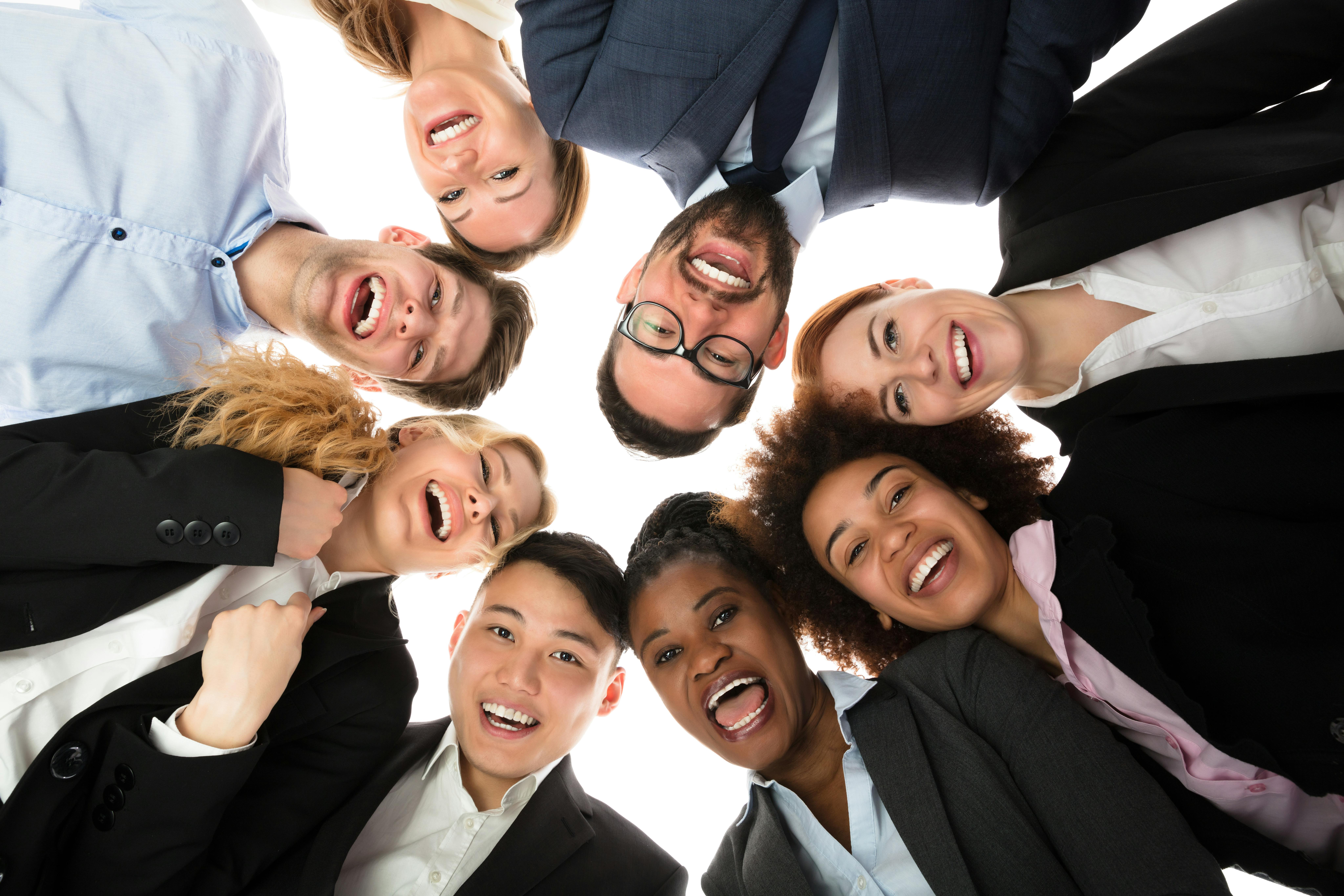 Smiling Businesspeople Standing Against White Background